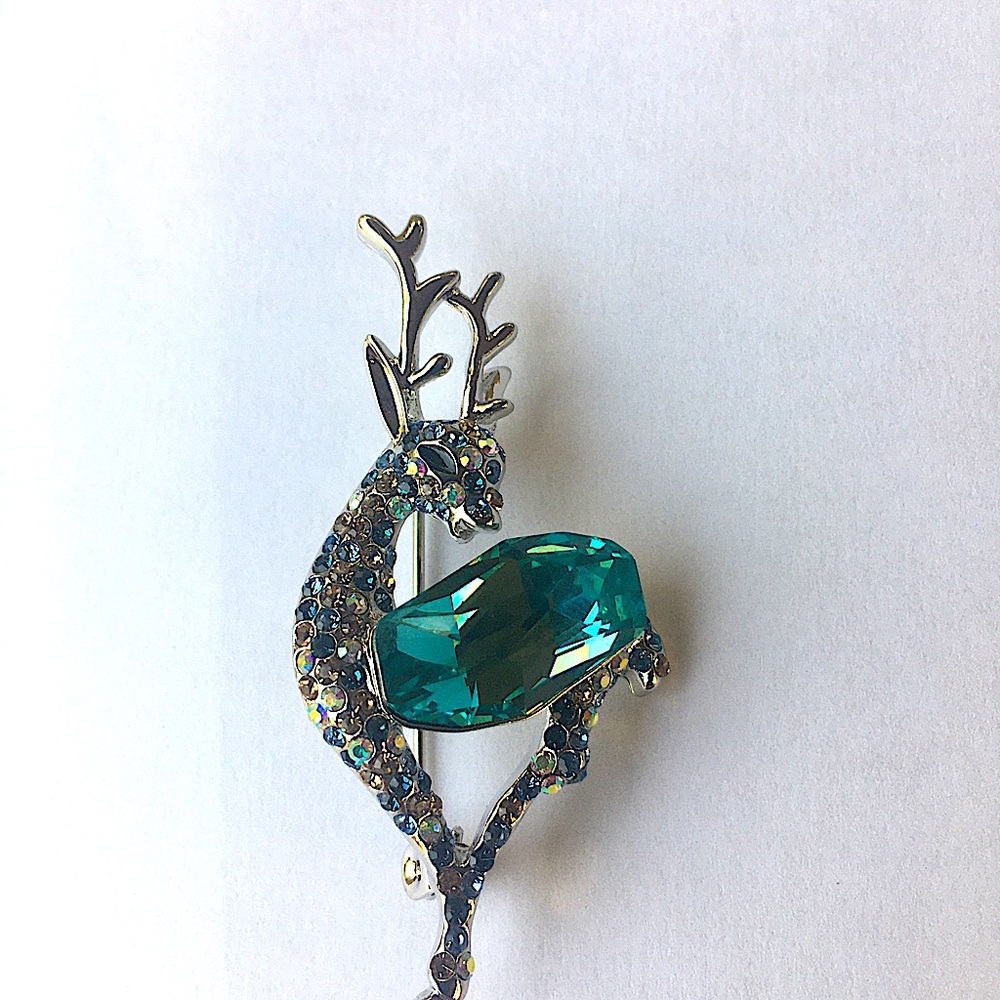 A new deer brooch pin with a large blue rhinestone